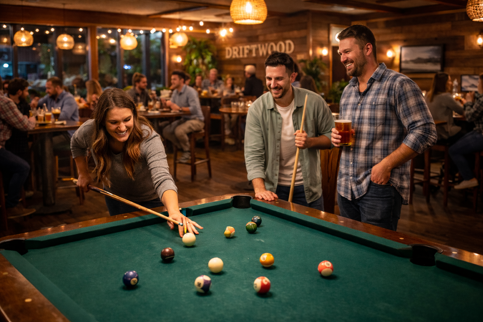 Pool tables and guests enjoying a casual night out at Driftwood Tavern